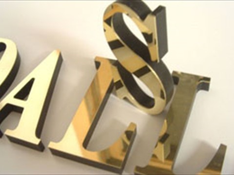 Laminated letters saying Dallas with polished brass face