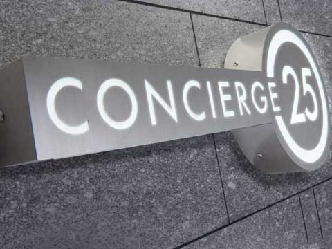 Integrated Fabricated stainless steel lighted sign showing 24 hour concierge